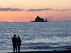 Couple silhouetted at sunset. Rialto Beach, Olympic Peninsula, Washington State. Art Print